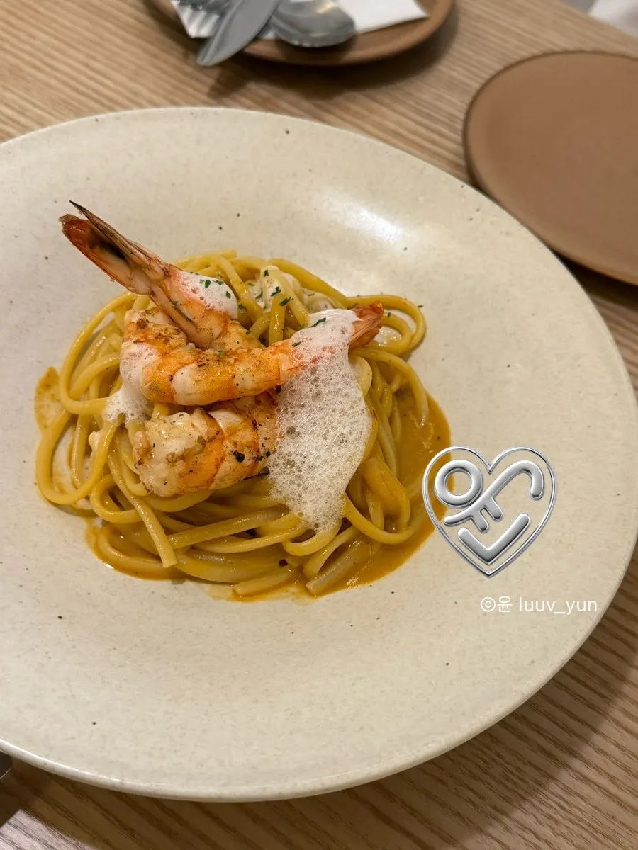 A plate of bisque pasta topped with shrimp