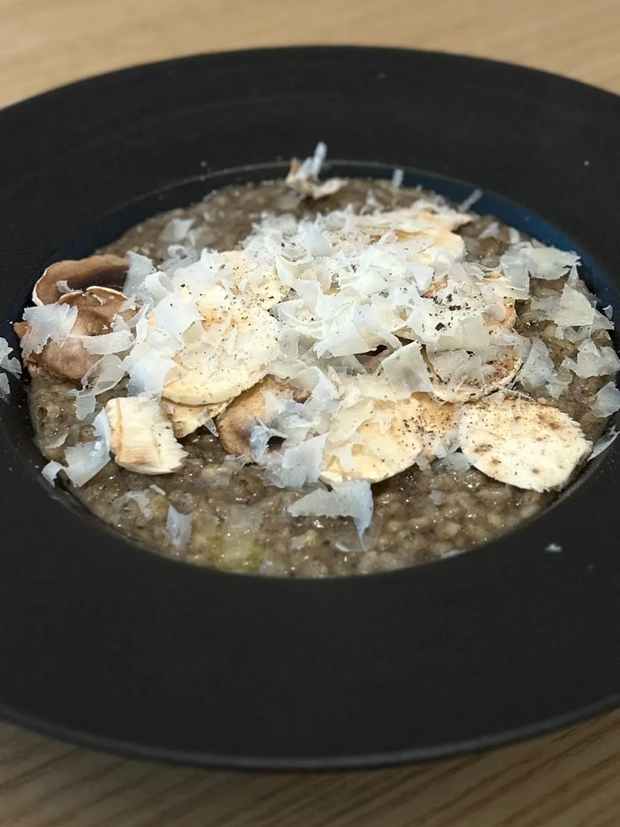 Truffle mushroom risotto topped with three kinds of mushrooms