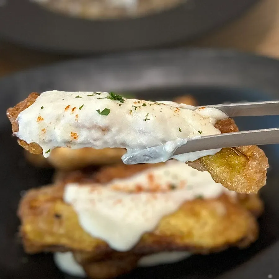 Crispy eggplant fritters topped with fish cream sauce