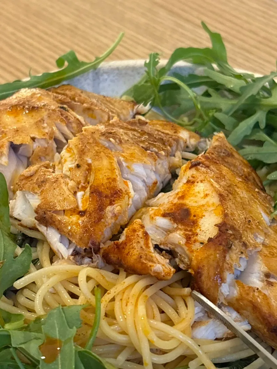 Mackerel compared in size to a hand
