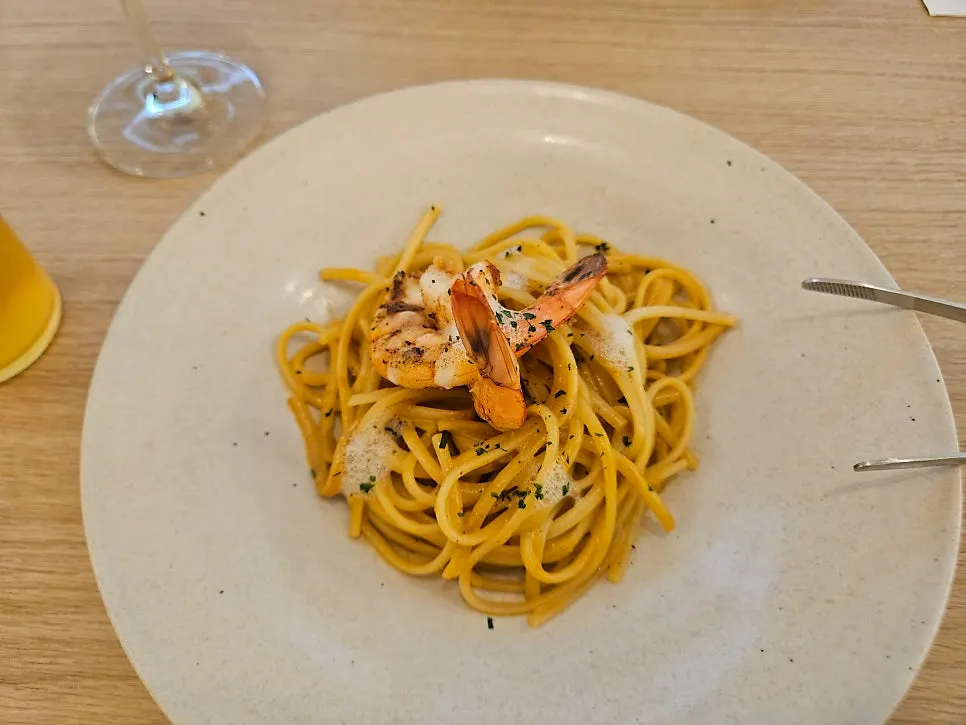 A plate of bisque pasta topped with shrimp