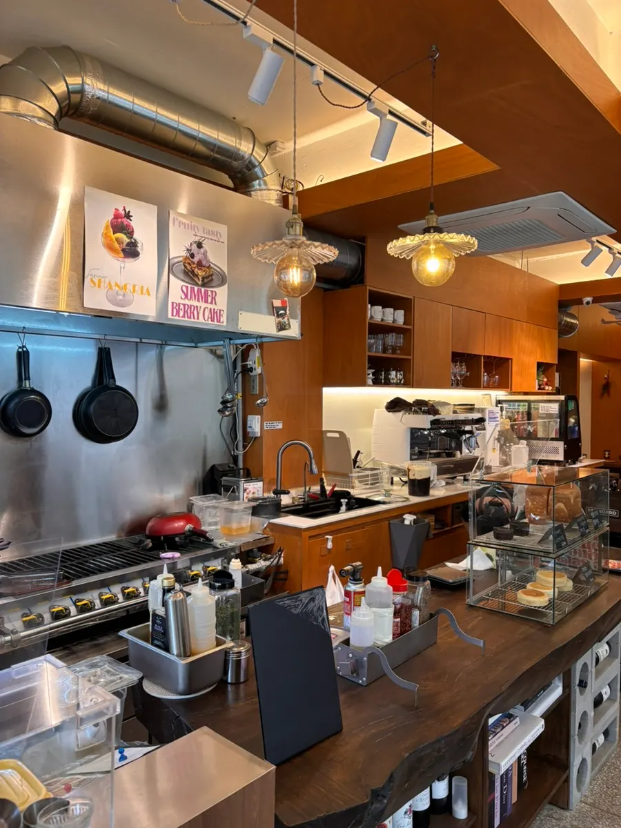 Open kitchen and wooden shelves near the store entrance
