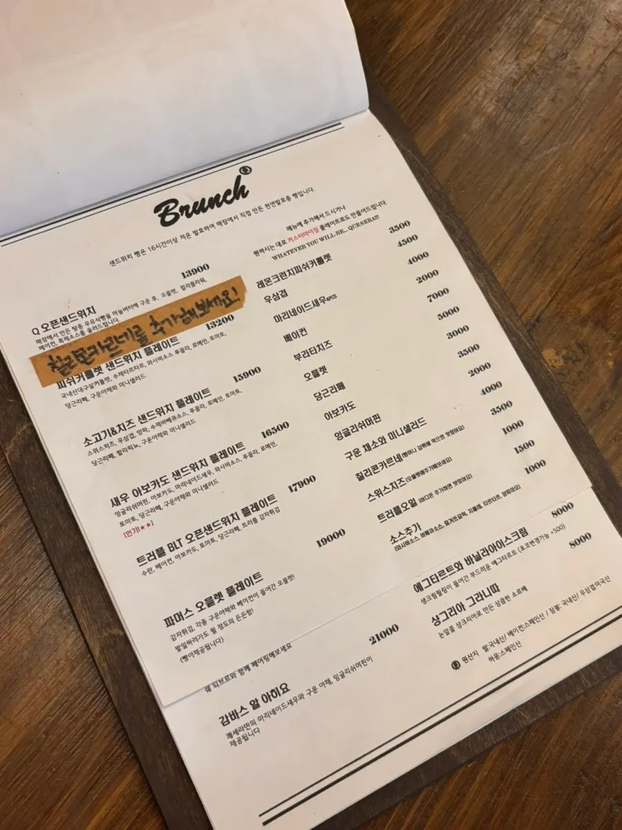 Menu board listing pasta, garlic shrimp, and drinks