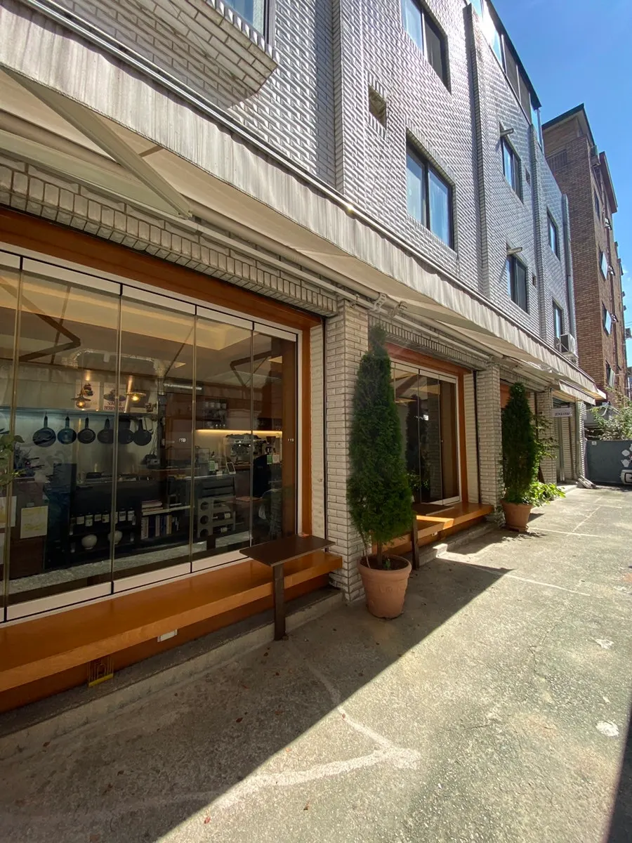 Outdoor table in front of the store styled with wine bottles and fruit decor