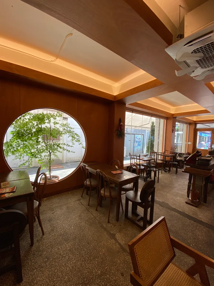 Wood-toned interior of Que Sera