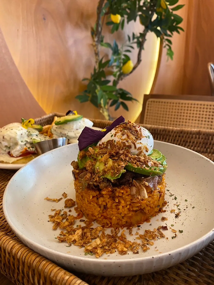 Truffle kimchi fried rice topped with avocado and poached egg