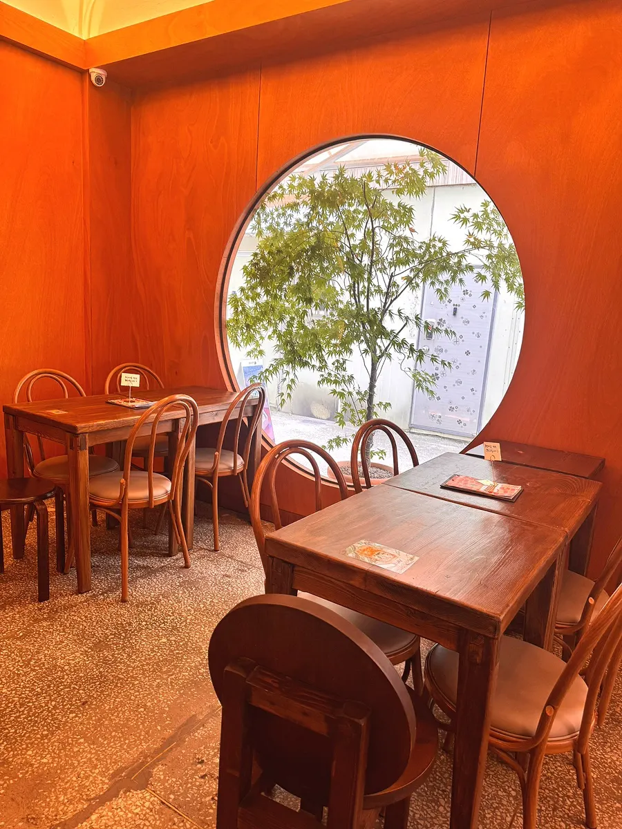 Wood-toned interior design inside Que Sera