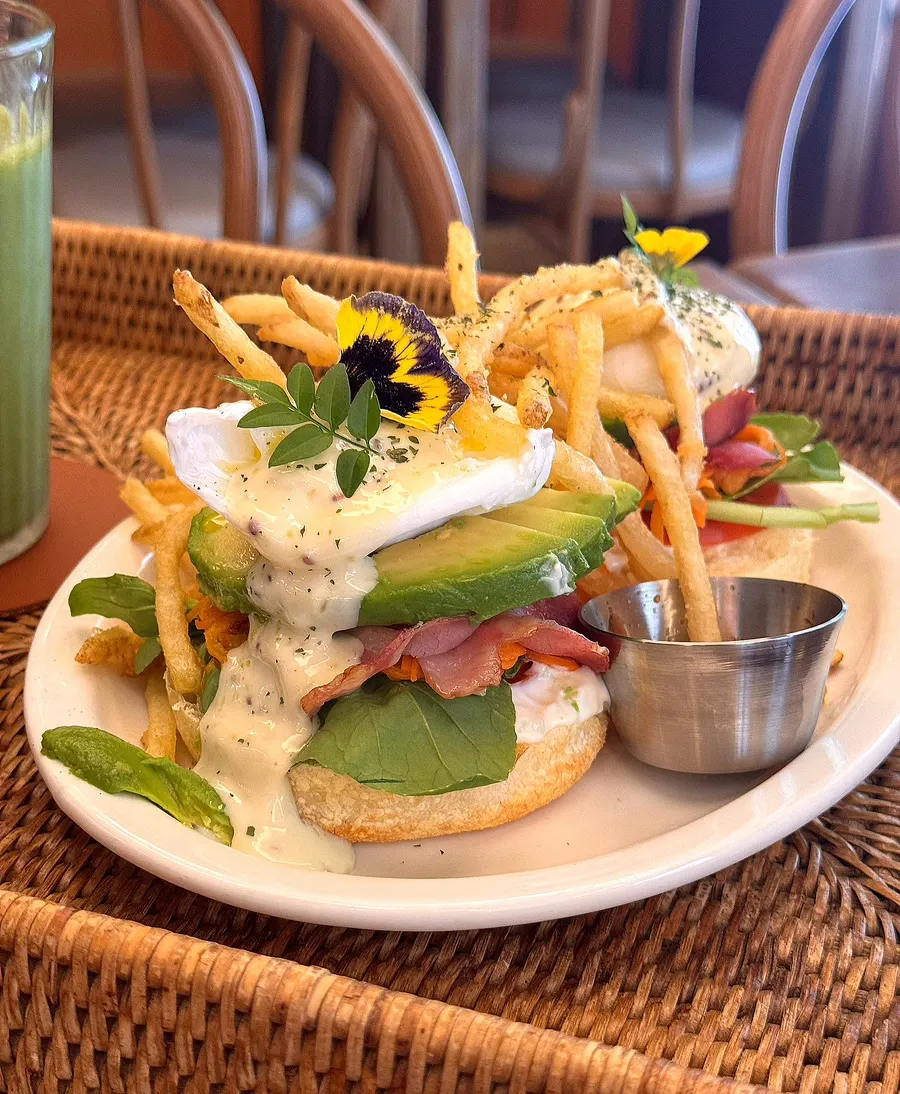 Truffle BLT open sandwich topped with fries and avocado