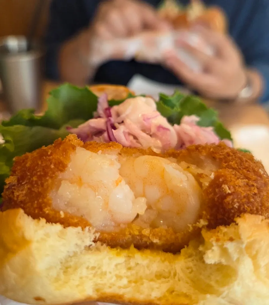 Whole Shrimp Quokka Shrimp Burger with a bite taken out