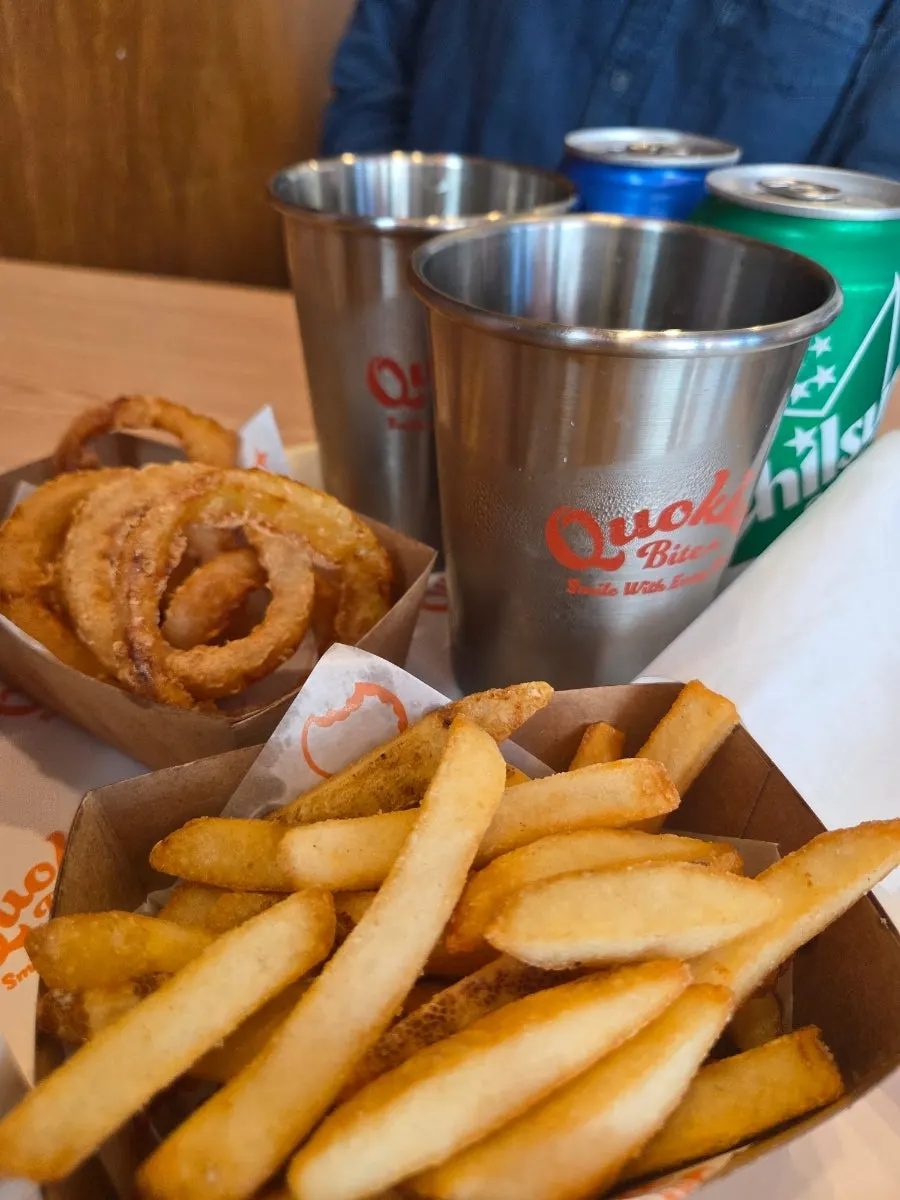 Burger and side dishes on the table at Quokka Bite