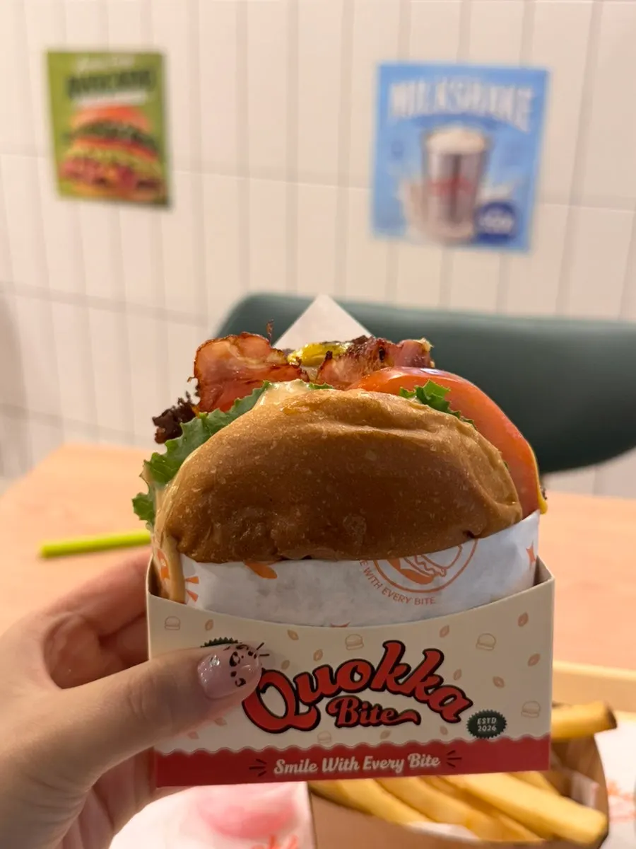 A bite taken out of the Grilled Quokka Double Burger
