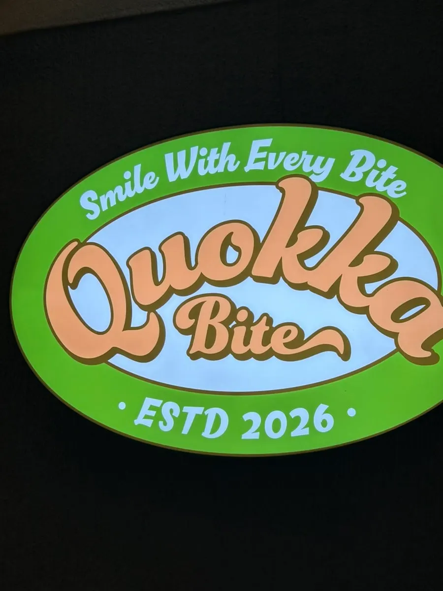 Store entrance with quokka mascot and orange accent color