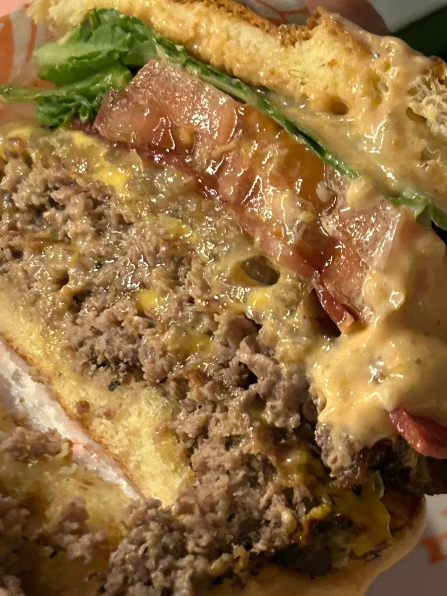 Cross-section of the bitten char-grilled double patty