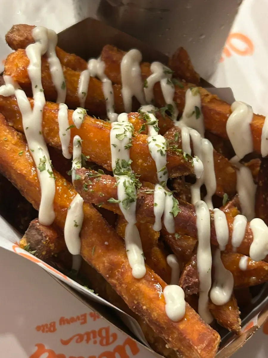 Sweet potato fries drizzled with honey and ranch sauce
