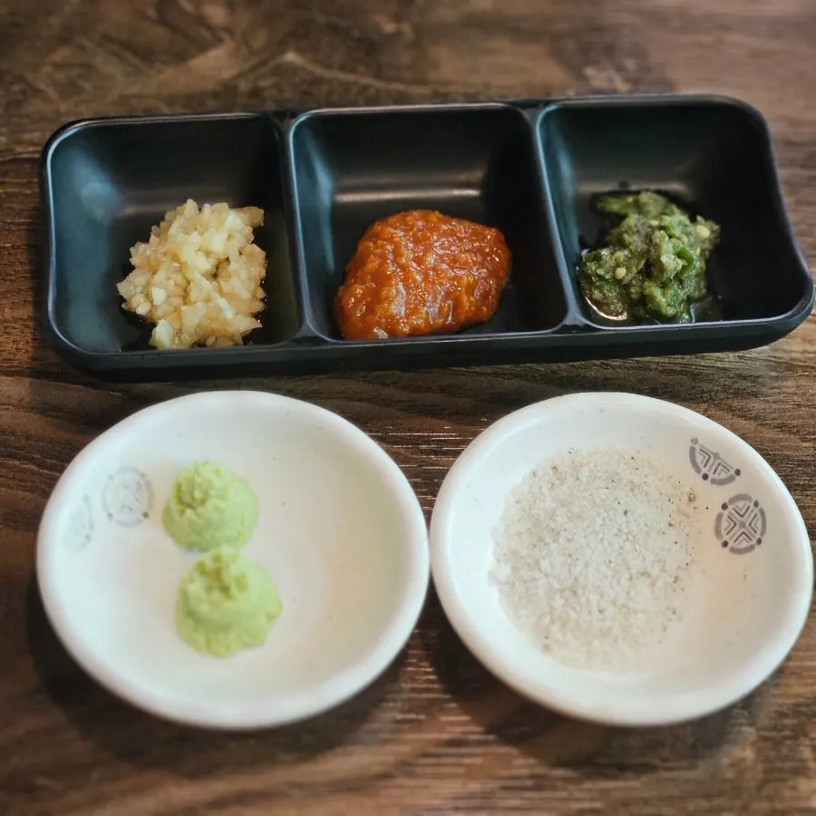 Green onion kimchi and other side dishes served with the meat