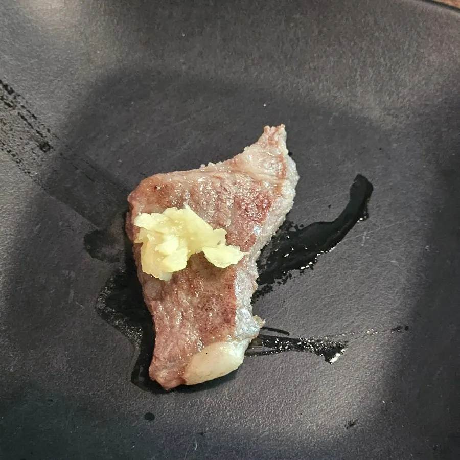 Charcoal-grilled LA galbi wrapped in a lettuce leaf