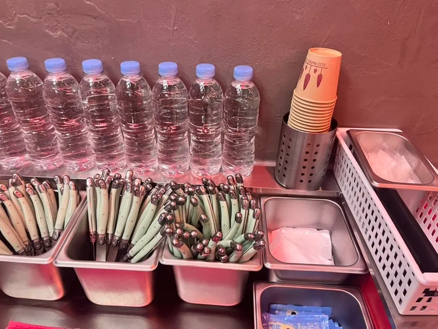 Self-serve bar with pickles and water