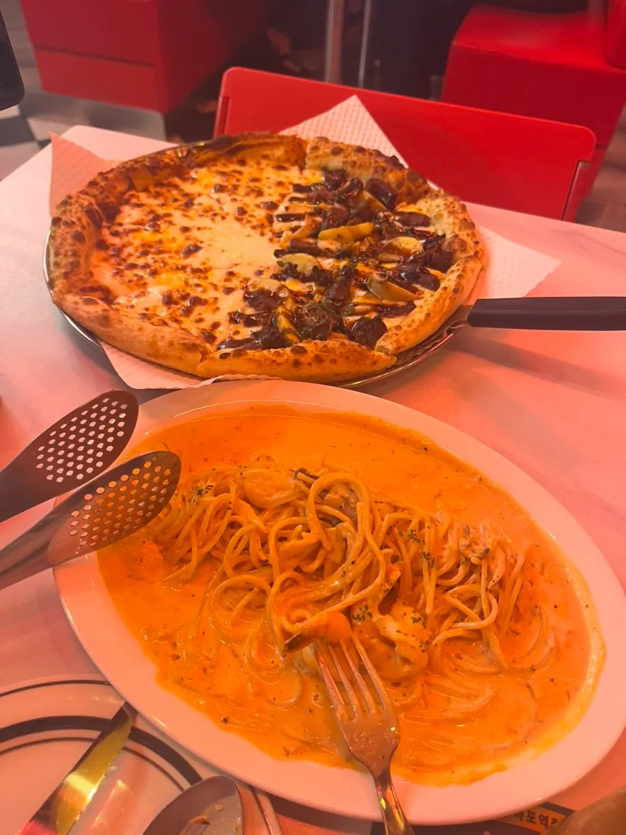A slice of Raccoon Cheese Waterfall Pizza with stretching cheese
