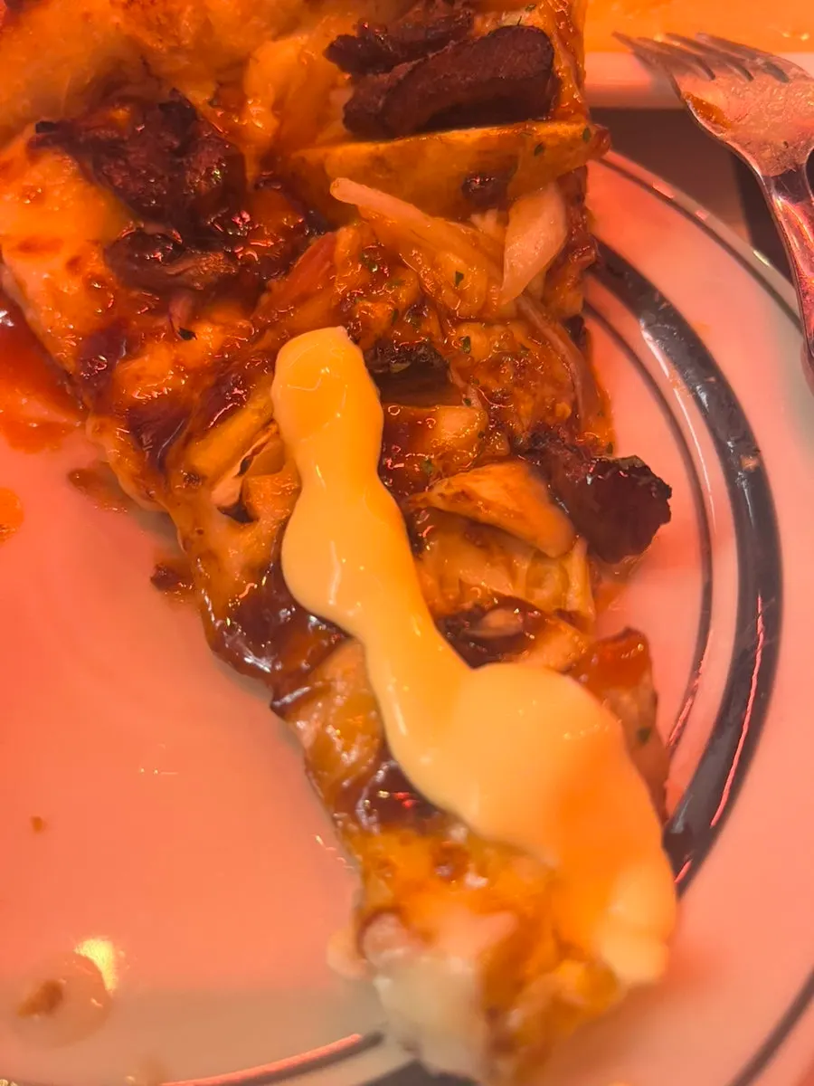 A slice of 1987 Steak Pizza