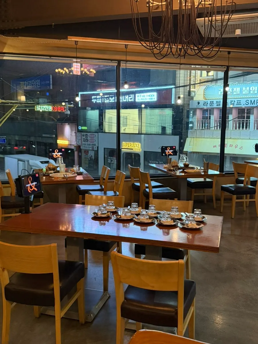 Interior of Rama & Babana's second-floor space with wood-tone tables
