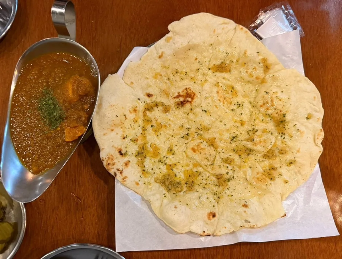Chicken curry and butter garlic naan set on the table