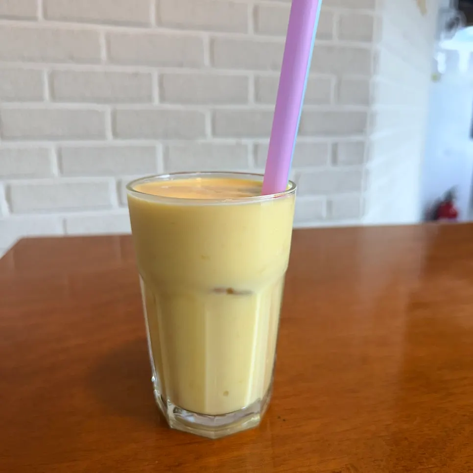 A glass of thick-textured mango lassi