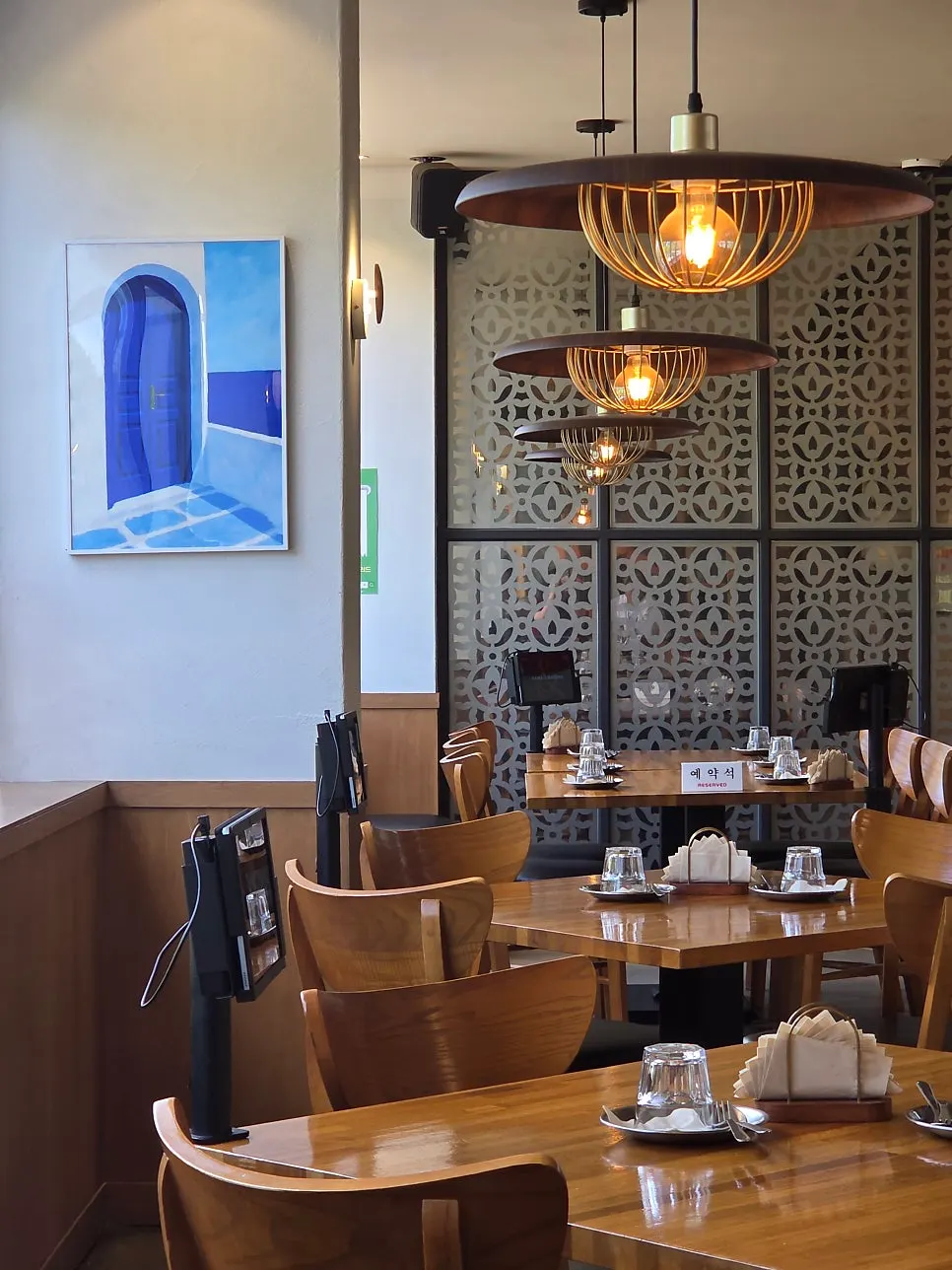 Restaurant interior with wood-tone tables and warm lighting