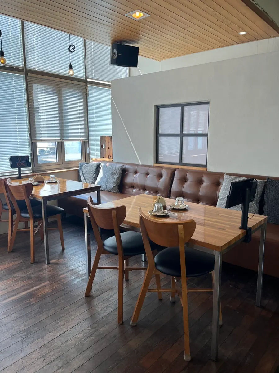 Window table with floor-to-ceiling glass