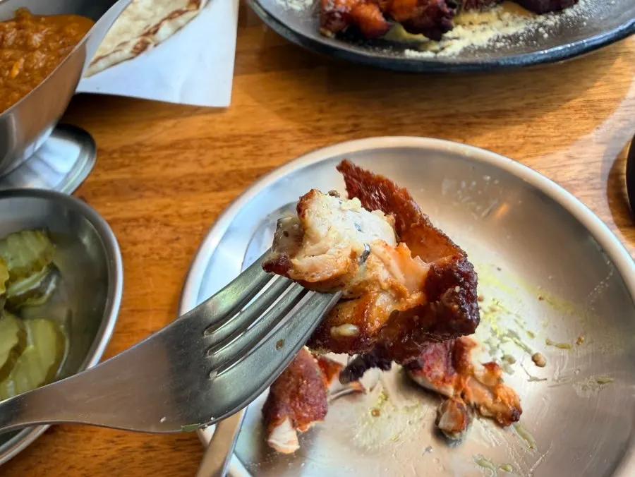 A piece of chicken before dipping in cream sauce