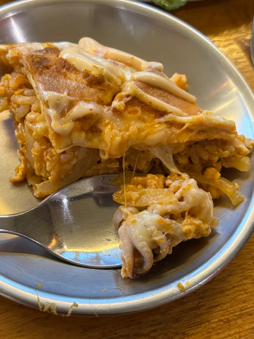 Ball-shaped bread crust sliced open on the nasi goreng