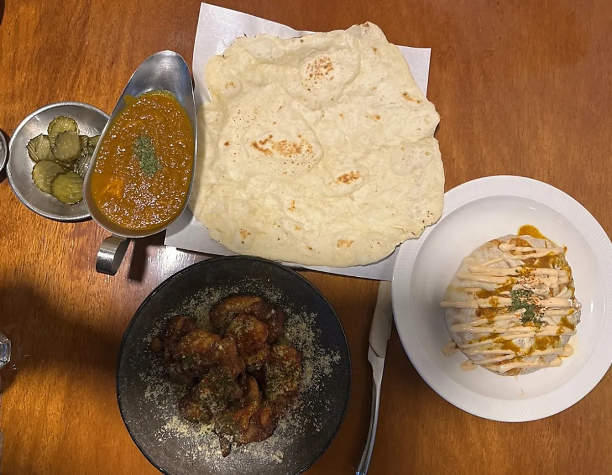Full spread of chicken curry, naan, nasi goreng and tandoori cream chicken