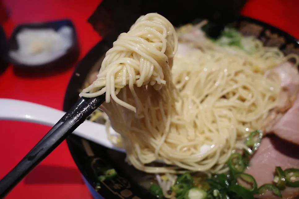 Thin hosomen noodles lifted with chopsticks