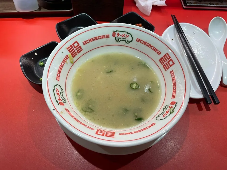 An empty bowl of ramen at Ramen Truck Konkuk University Branch, broth and all