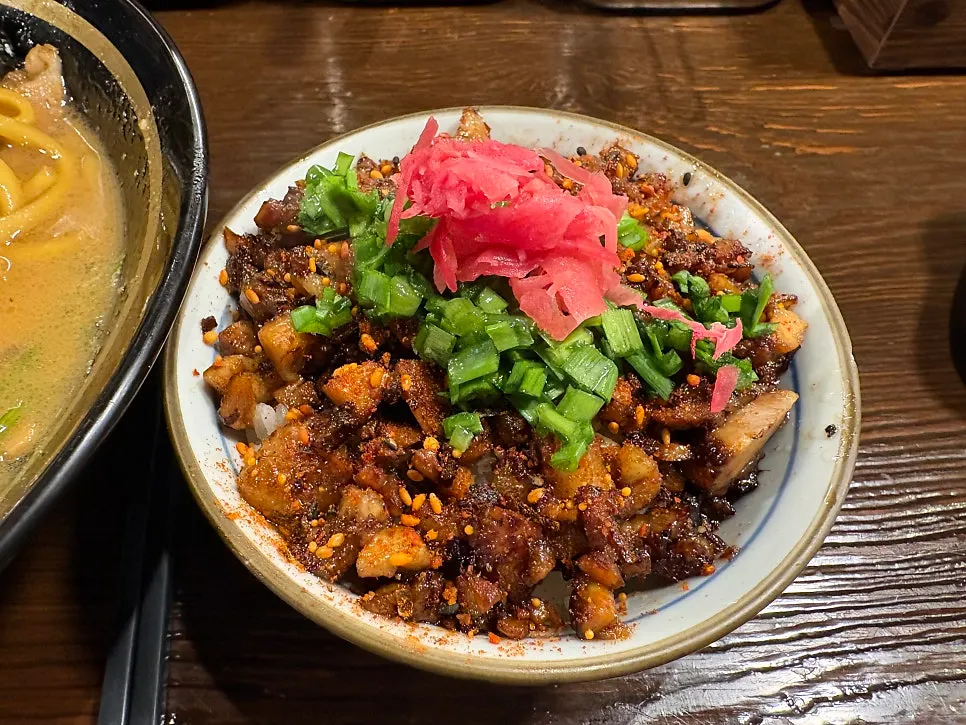 Thick medium noodles lifted up from the bowl