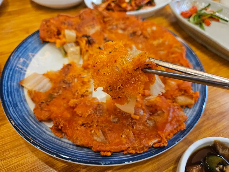 A cross-section of kimchijeon packed with kimchi
