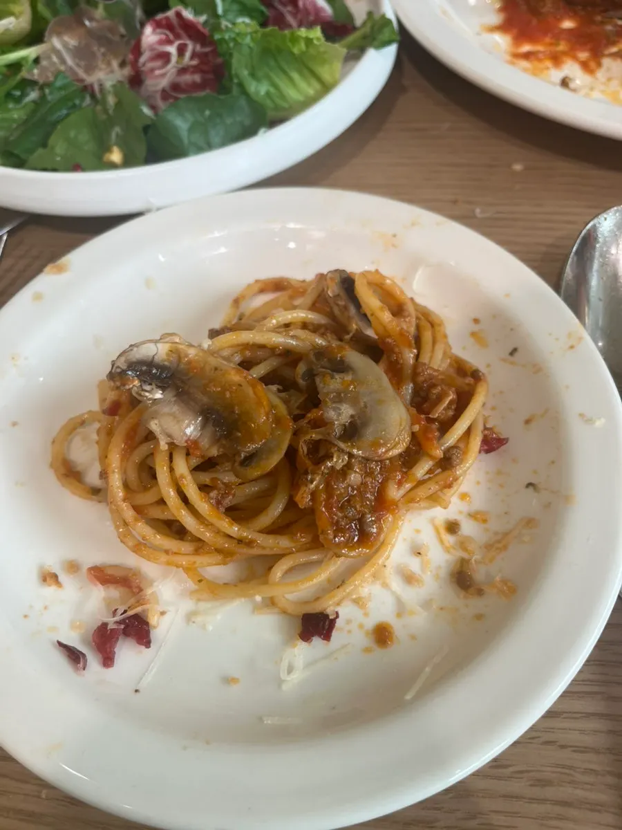 Table setting with pasta and salad