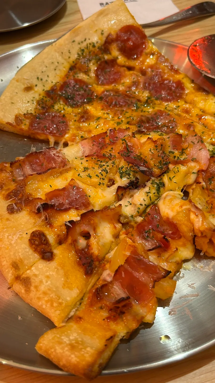 Cheese pull on a pepperoni pizza slice