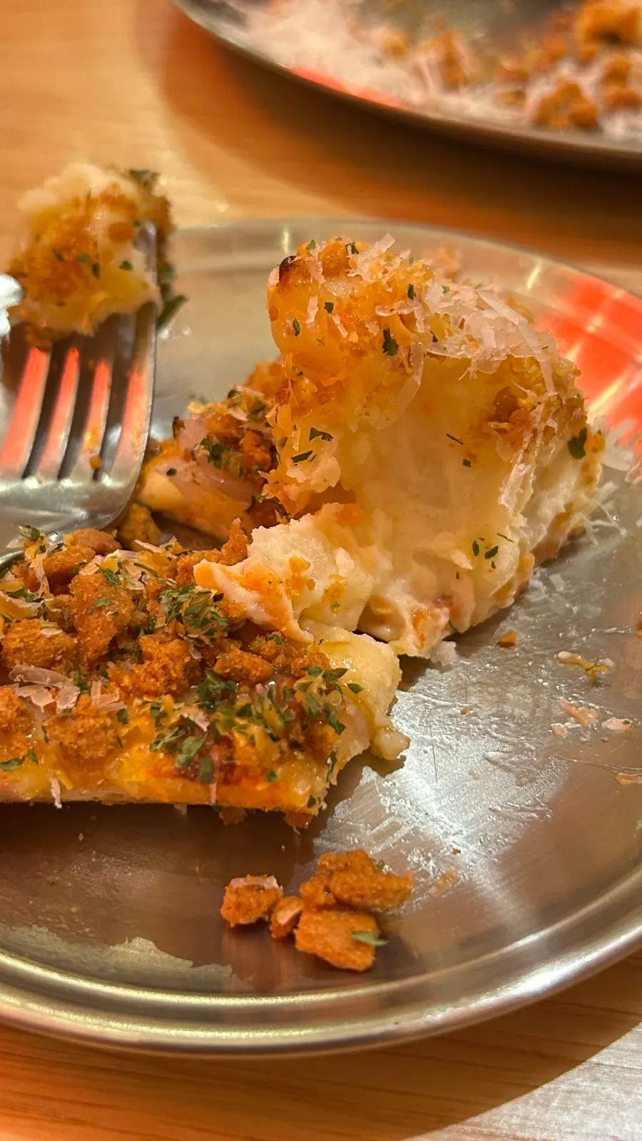 Lifting a slice of Brown Potato pizza