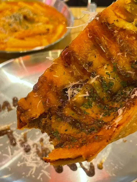 A thin-crust slice of American Bulbeok Pizza