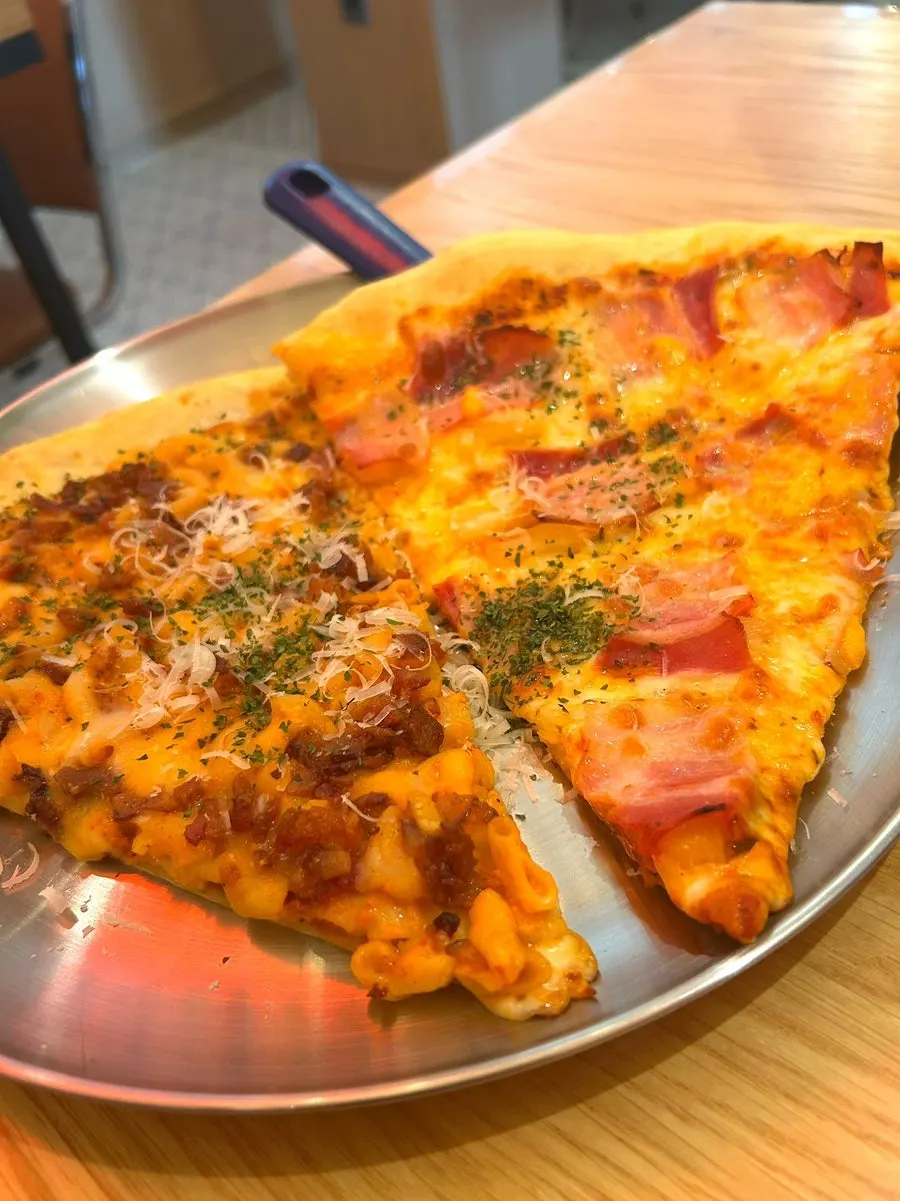 A large American-style slice of pizza
