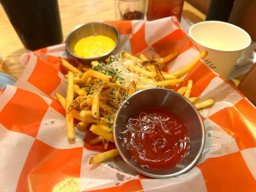 Plate of truffle fries topped with grated cheese