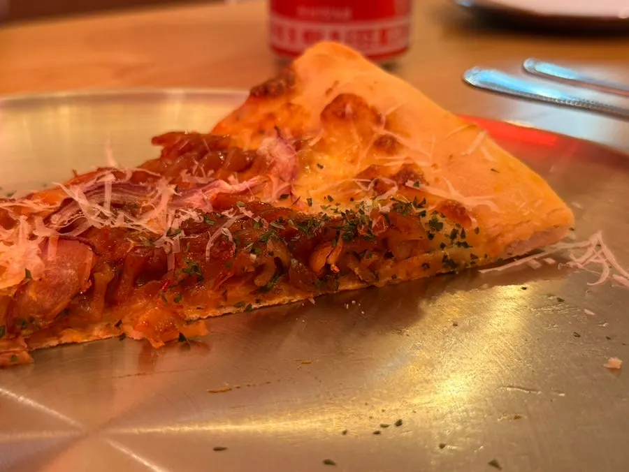 Cross-section of thin dough topped with fusilli