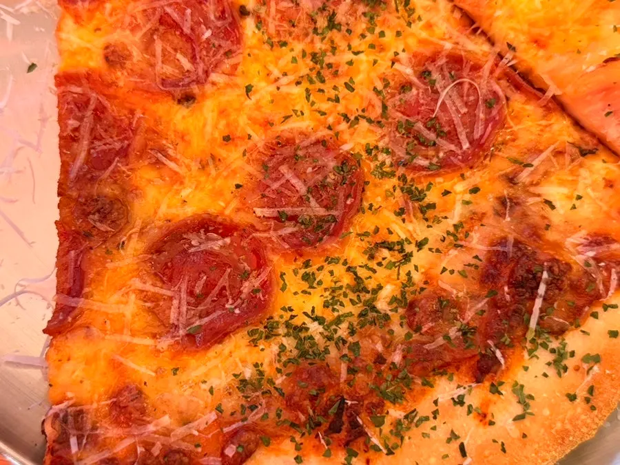 Pepperoni pizza slice cut in half