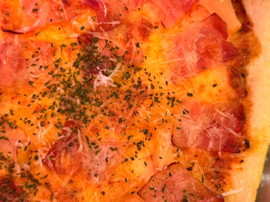Hawaiian pizza topped with pineapple and bacon