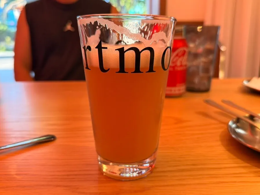 Craft draft beer served alongside pizza and chicken