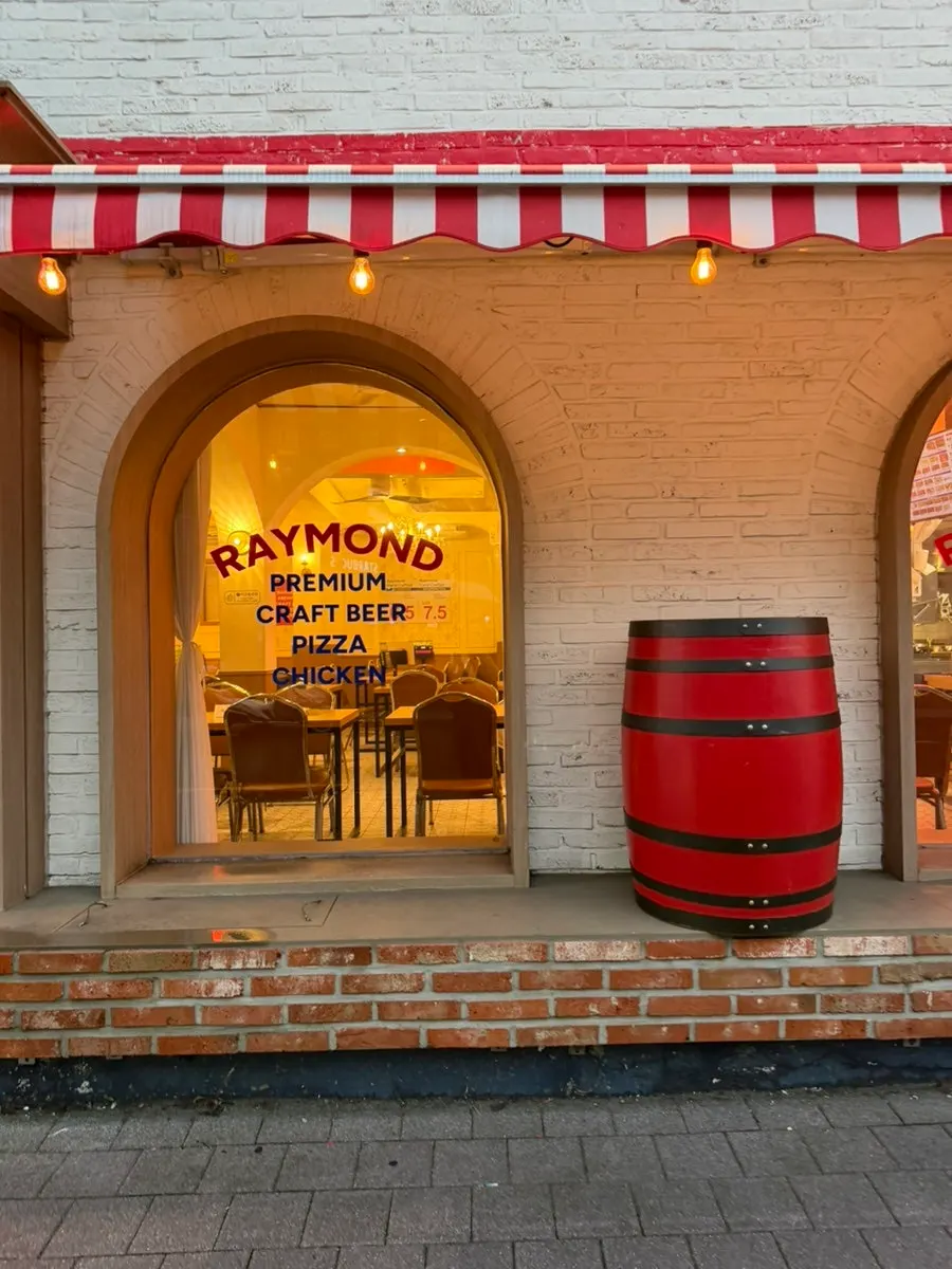 Entrance of Raymond Isu Branch with a red oak barrel