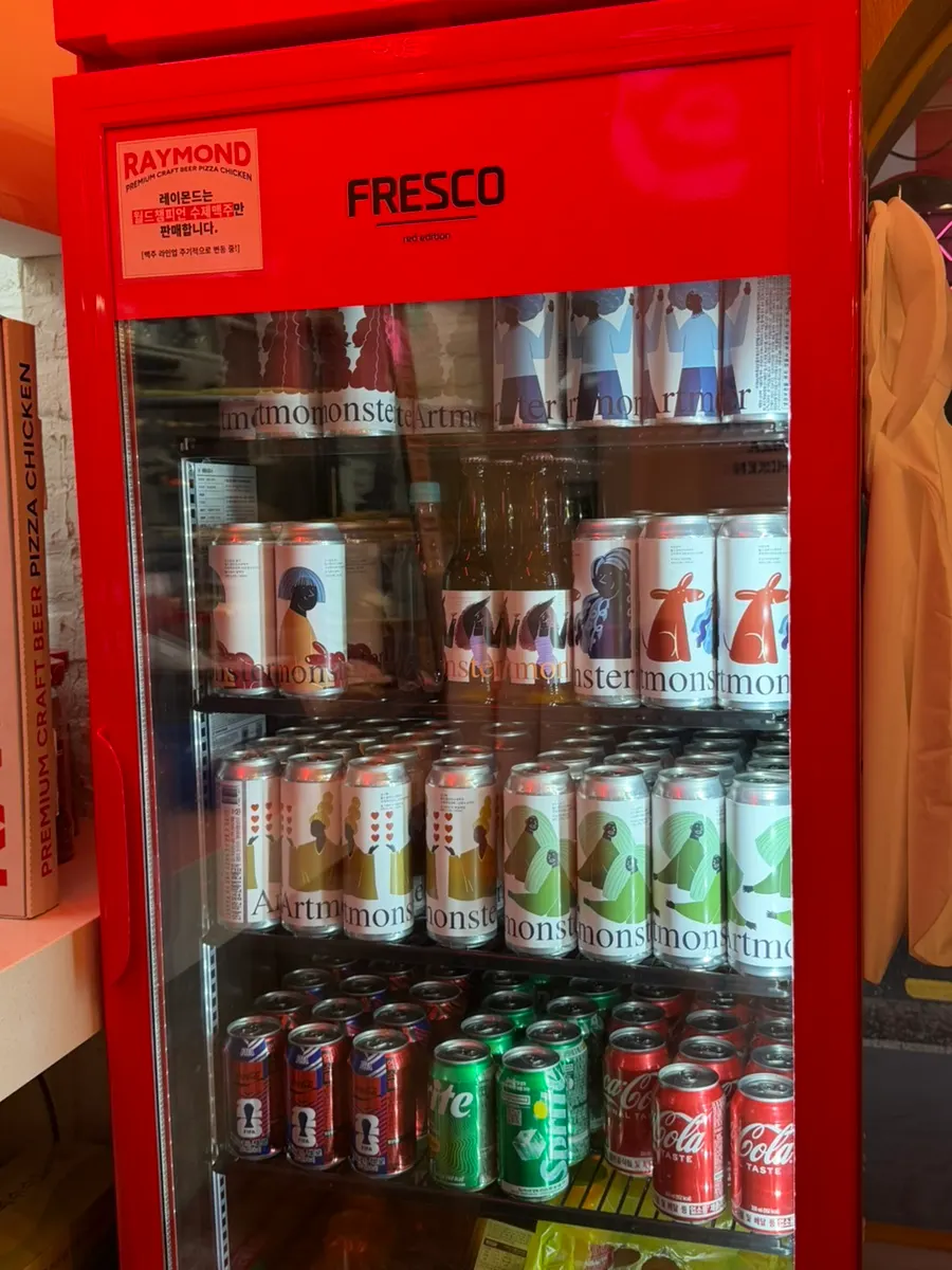 Red fridge stocked with bottled beers and drinks