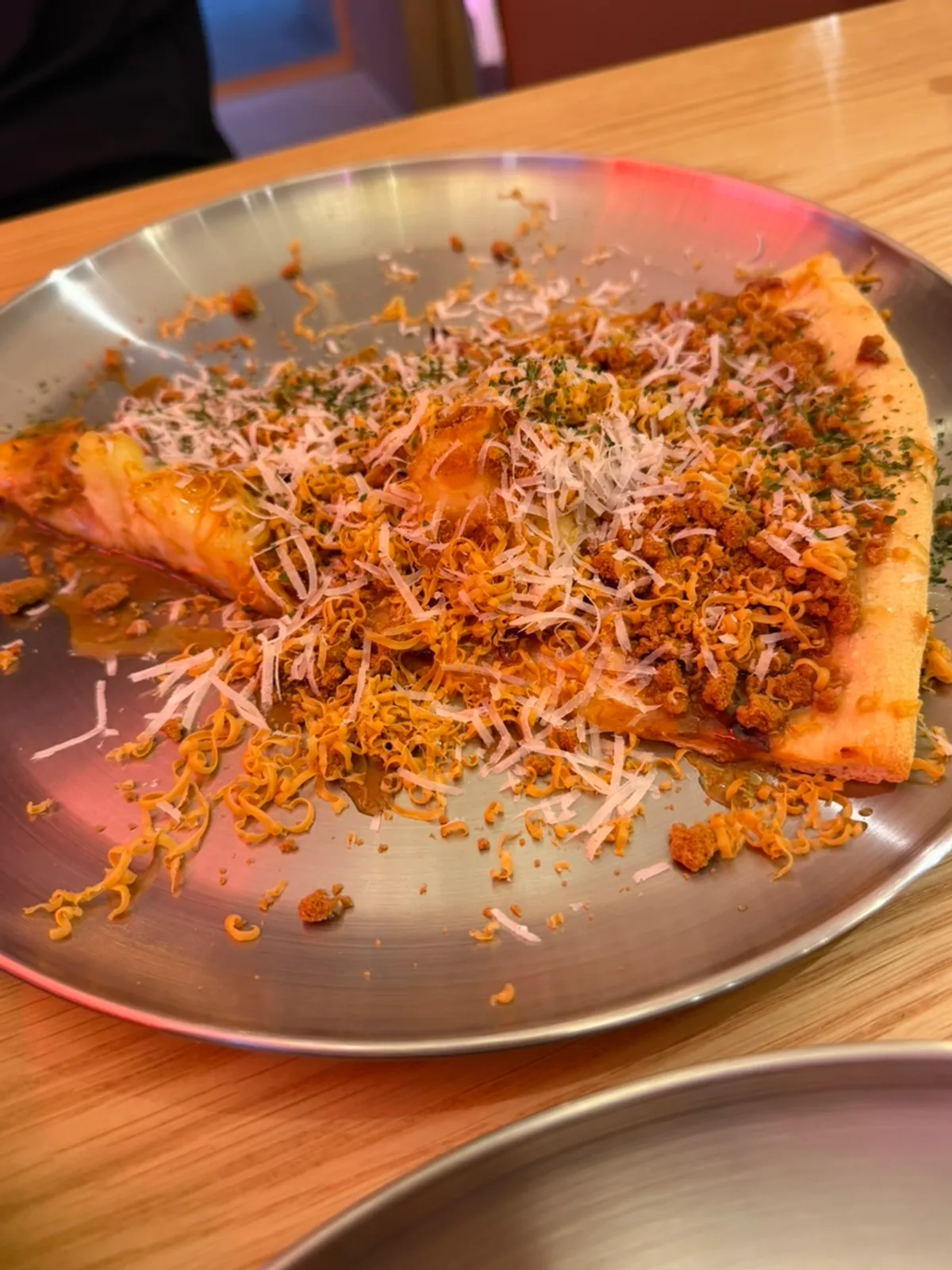 A slice of Big Brown Potato Pizza topped with Lotus