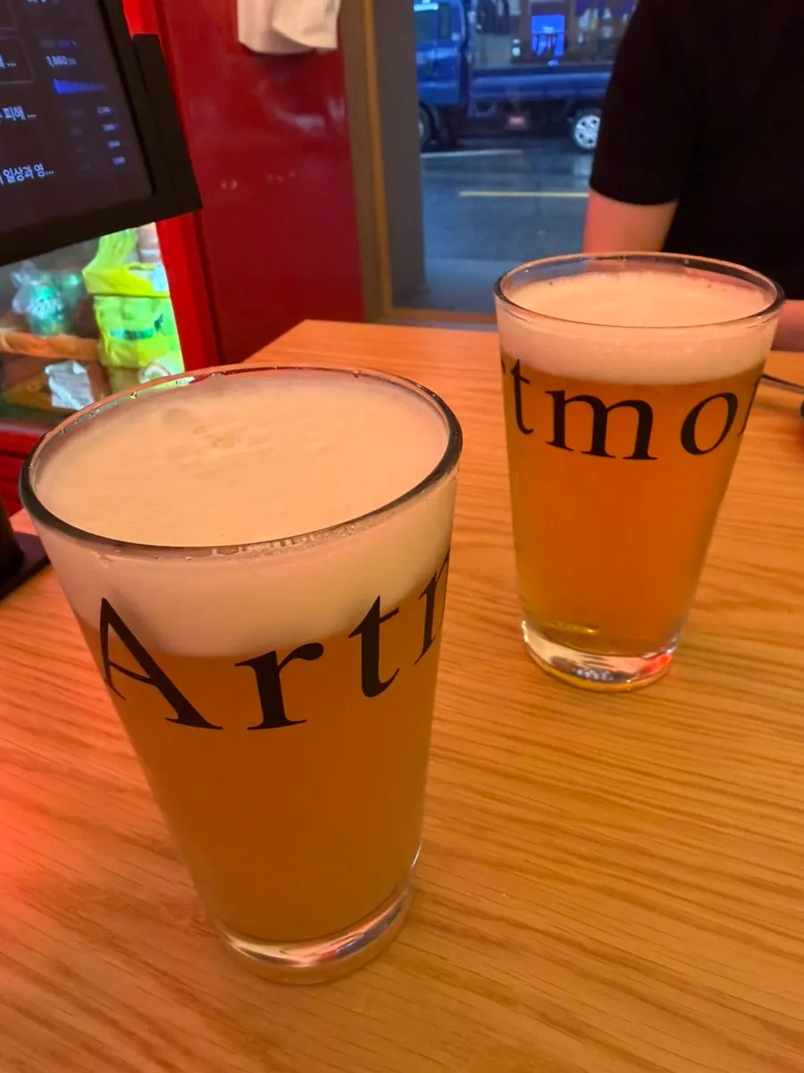Slice pizzas served with two glasses of craft draft beer