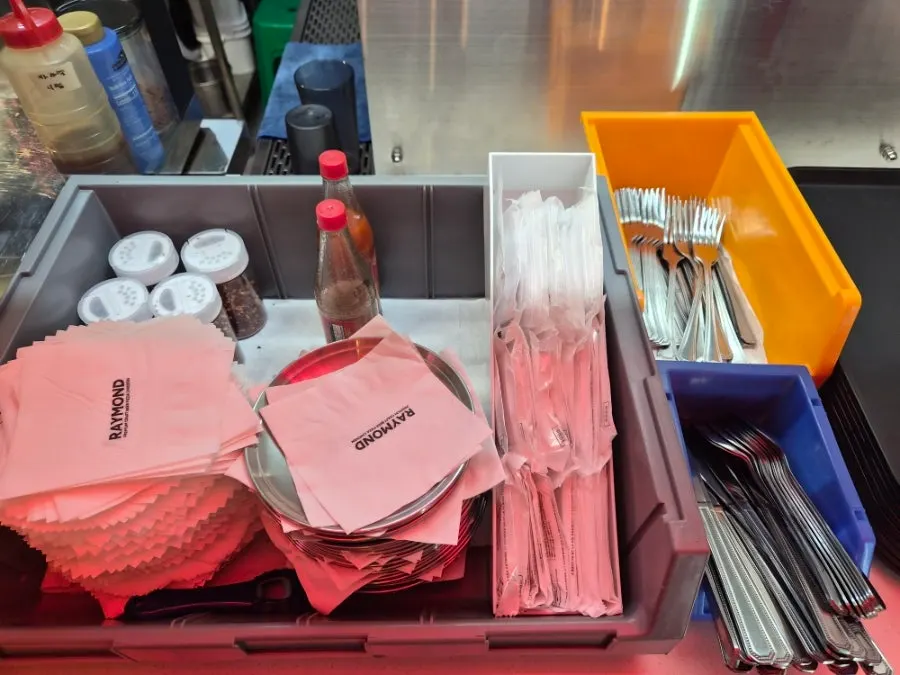 Self-serve bar with wet wipes, small plates, and sauces